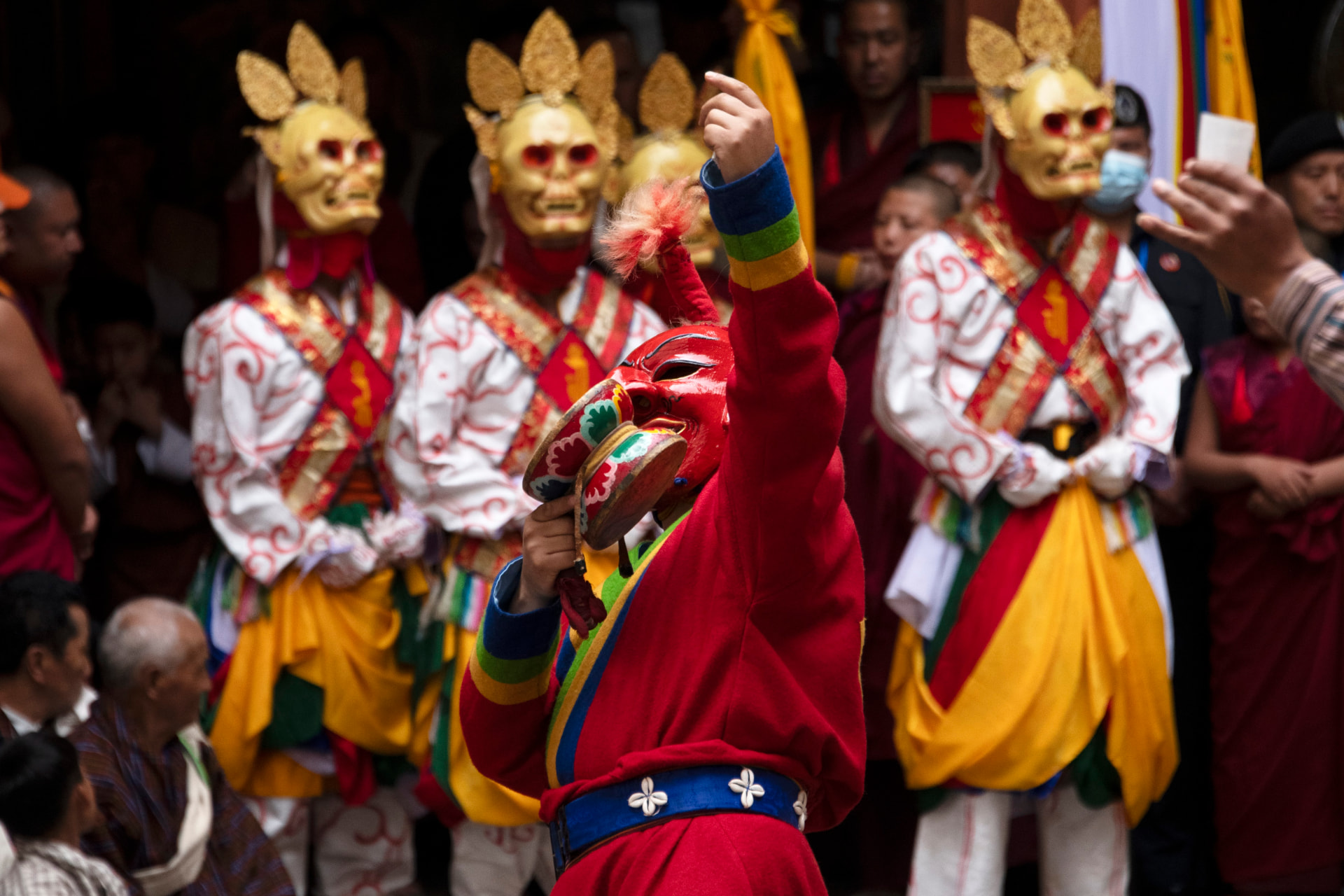 Atsara dancers in traditional Bhutanese festival masks and colourful costumes